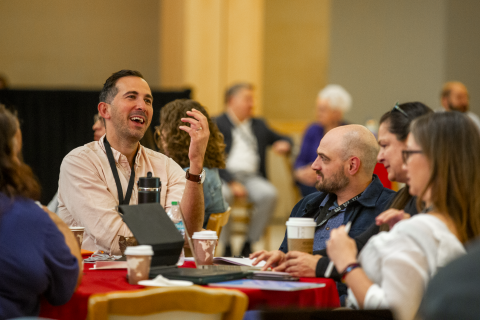 Collaborative members talk with each other during the annual conference